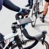 Quad Lock Out Front Mount securely attached to a bike handlebar, showcasing its sleek design and compatibility with various devices.