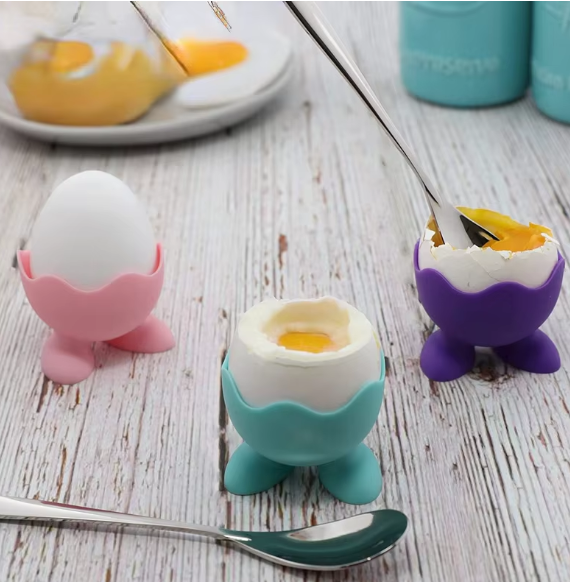 Colorful silicone egg cups with a cute feet design, perfect for holding boiled eggs or small items like facial sponges