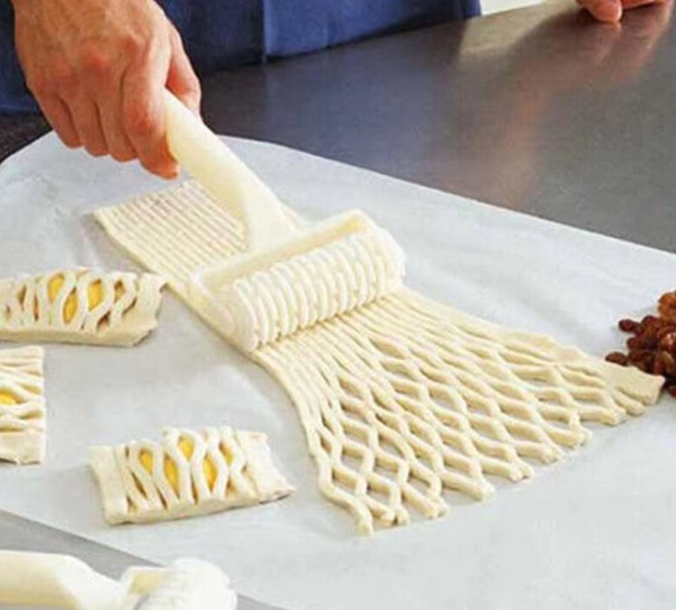 Sturdy plastic pastry roller cutter for baking pies, cookies, and pizzas with ease.