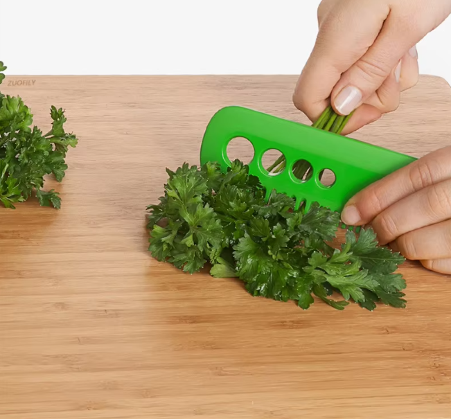 Vegetable herb eliminator in green color, designed to easily strip leaves from stems of herbs like parsley and cilantro.